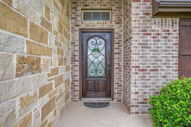 view of exterior entry with brick siding