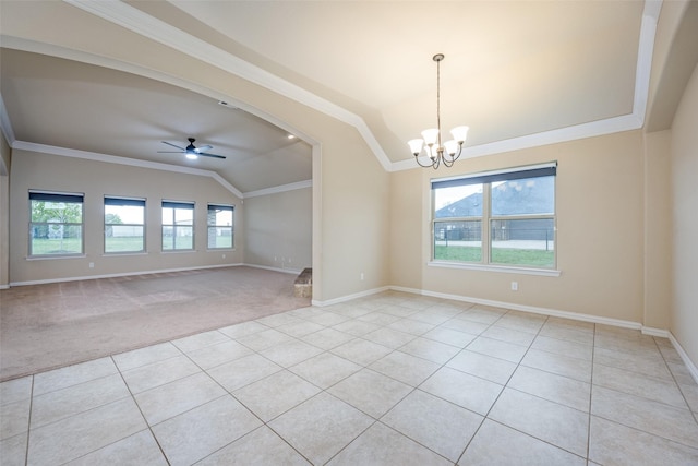 spare room with a wealth of natural light, vaulted ceiling, crown molding, and ceiling fan with notable chandelier