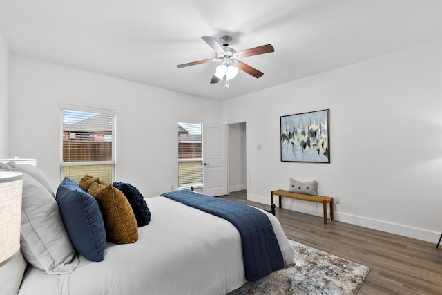 bedroom featuring baseboards, ceiling fan, and wood finished floors