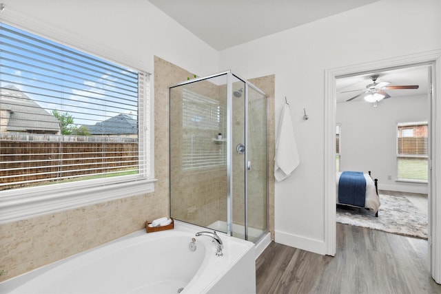 ensuite bathroom featuring wood finished floors, a garden tub, connected bathroom, and a stall shower