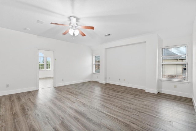unfurnished room featuring ceiling fan, visible vents, and wood finished floors