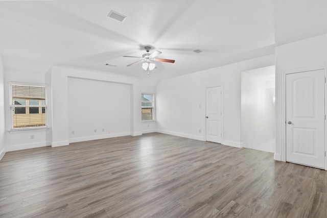 unfurnished living room featuring visible vents, a ceiling fan, light wood-style flooring, and baseboards