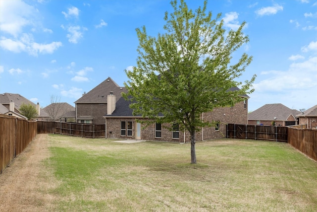 view of yard with a fenced backyard