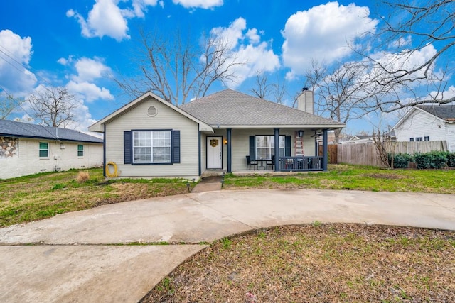 209 E County Line Rd, Royse City, TX 75189 - view of front of house with concrete driveway, fence, a front lawn, covered porch, and a chimney