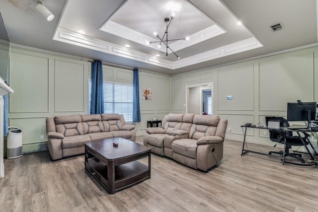 209 E County Line Rd, Royse City, TX 75189 - living area with crown molding, a raised ceiling, visible vents, a decorative wall, and a notable chandelier