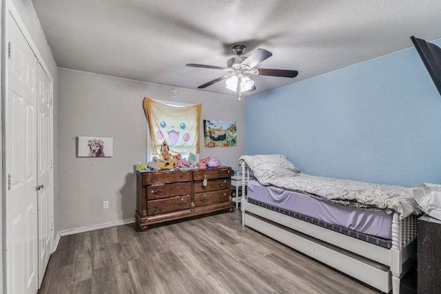 209 E County Line Rd, Royse City, TX 75189 - bedroom featuring baseboards, wood finished floors, a closet, and a ceiling fan