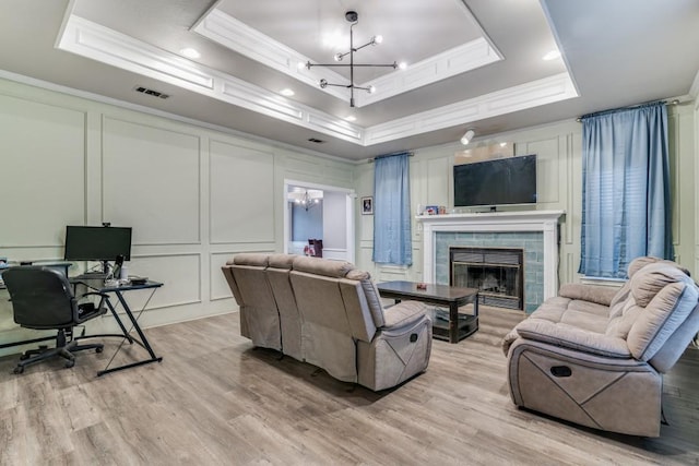 209 E County Line Rd, Royse City, TX 75189 - living room featuring a chandelier, a decorative wall, and a raised ceiling