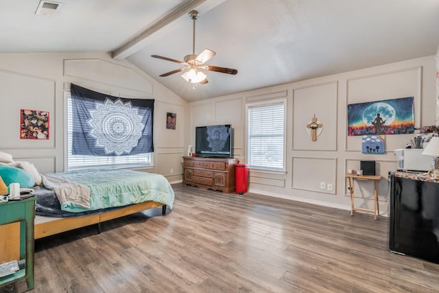 209 E County Line Rd, Royse City, TX 75189 - bedroom featuring a decorative wall, visible vents, ceiling fan, wood finished floors, and vaulted ceiling with beams