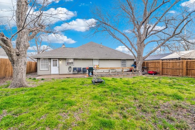 209 E County Line Rd, Royse City, TX 75189 - rear view of house featuring a chimney, a fenced backyard, a lawn, a shingled roof, and a patio area