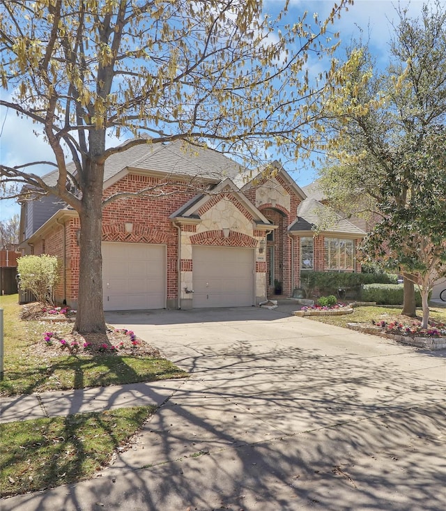 view of front facade featuring brick siding, an attached garage, and concrete driveway