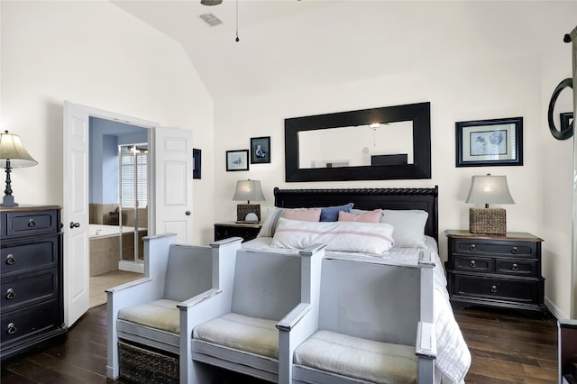 bedroom featuring lofted ceiling, dark wood-style floors, connected bathroom, and visible vents