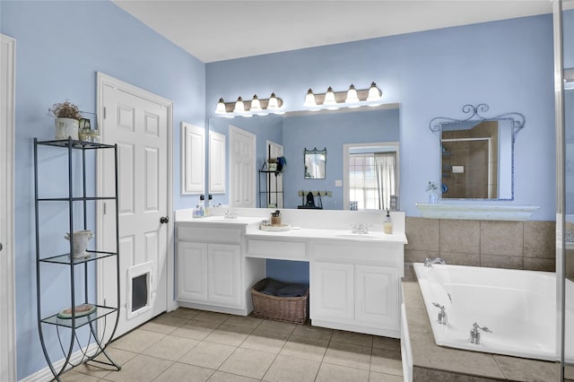 bathroom with a sink, a bath, double vanity, a tile shower, and tile patterned flooring