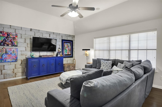 living room featuring lofted ceiling, baseboards, ceiling fan, and dark wood-style flooring