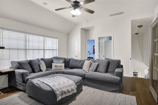 living area with vaulted ceiling, a ceiling fan, wood finished floors, and visible vents