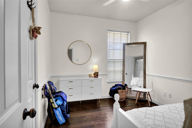bedroom with a ceiling fan, baseboards, and dark wood finished floors