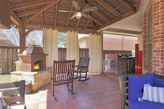 view of patio / terrace featuring a fenced backyard, a gazebo, an outdoor brick fireplace, and ceiling fan