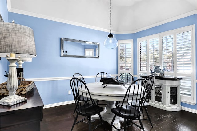 dining space featuring baseboards, wood finished floors, and ornamental molding