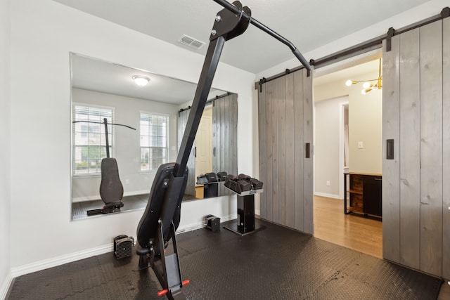 2549 Stella Ln, Northlake, TX 76247 - workout room featuring a barn door and baseboards