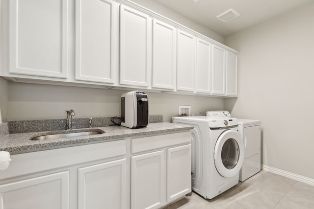 2549 Stella Ln, Northlake, TX 76247 - washroom featuring cabinet space, washer and clothes dryer, baseboards, and light tile patterned flooring