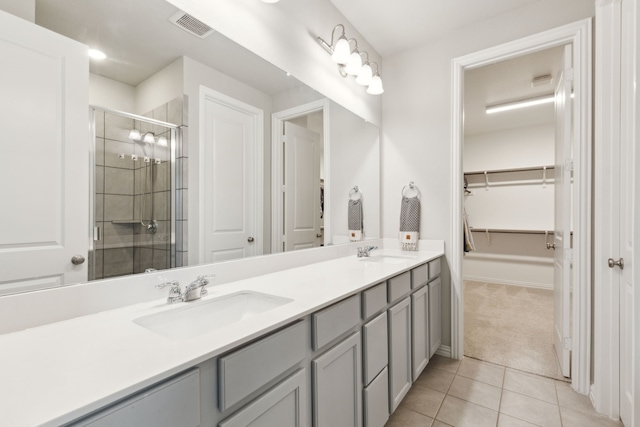 2549 Stella Ln, Northlake, TX 76247 - full bathroom featuring a shower stall, tile patterned flooring, double vanity, and a walk in closet