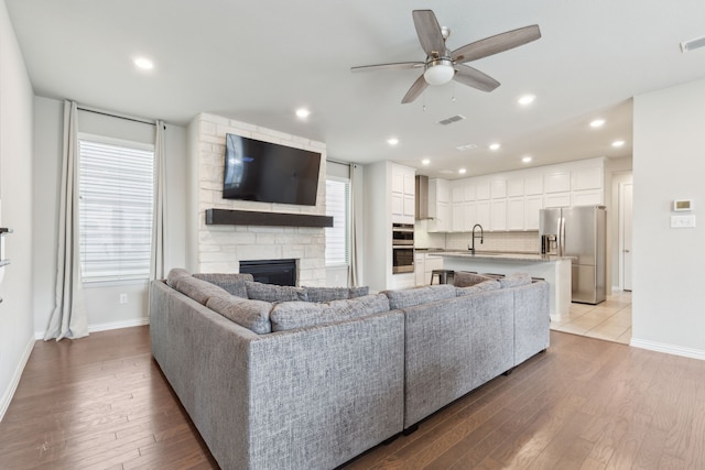 2549 Stella Ln, Northlake, TX 76247 - living room with a fireplace, ceiling fan, light wood-type flooring, baseboards, and recessed lighting