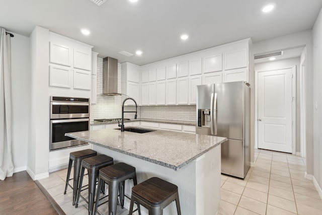 2549 Stella Ln, Northlake, TX 76247 - kitchen with stainless steel appliances, wall chimney exhaust hood, a sink, baseboards, and recessed lighting