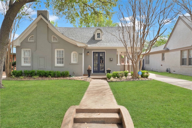 930 N Clinton Ave, Dallas, TX 75208 - view of front of house featuring french doors, a yard, stucco siding, and a shingled roof