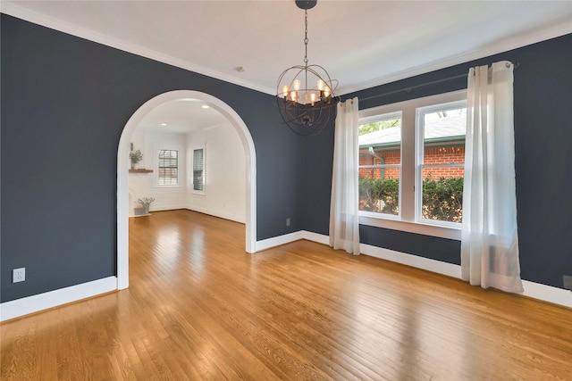 930 N Clinton Ave, Dallas, TX 75208 - unfurnished living room featuring baseboards, arched walkways, wood finished floors, and recessed lighting