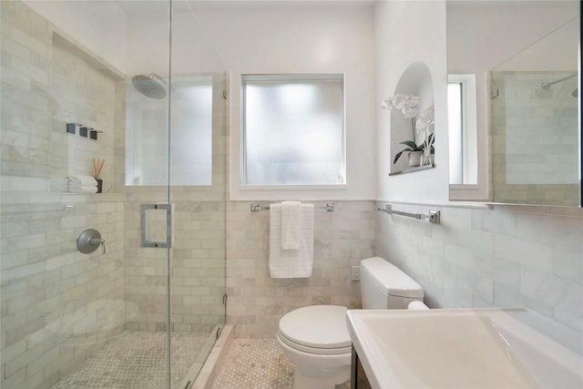 930 N Clinton Ave, Dallas, TX 75208 - bathroom featuring a sink, tile walls, a wainscoted wall, toilet, and shower / bath combination with curtain