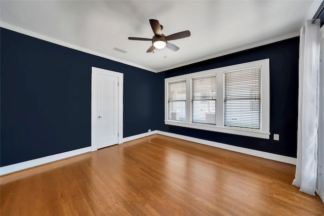 930 N Clinton Ave, Dallas, TX 75208 - empty room with ceiling fan, wood finished floors, baseboards, and crown molding