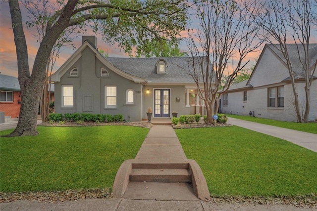 930 N Clinton Ave, Dallas, TX 75208 - view of front of house featuring french doors, a yard, stucco siding, and a shingled roof