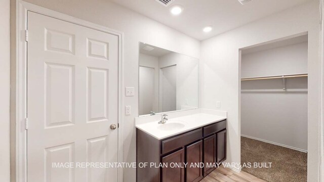 12520 Tarres Ct, Lorena, TX 76655 - bathroom with vanity, a walk in closet, and recessed lighting