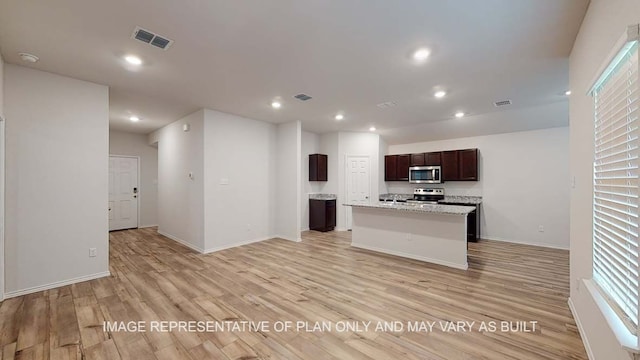 12520 Tarres Ct, Lorena, TX 76655 - kitchen with a center island with sink, recessed lighting, appliances with stainless steel finishes, and light wood-type flooring