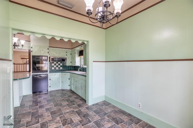 kitchen with visible vents, stone finish floor, a chandelier, a sink, and black oven
