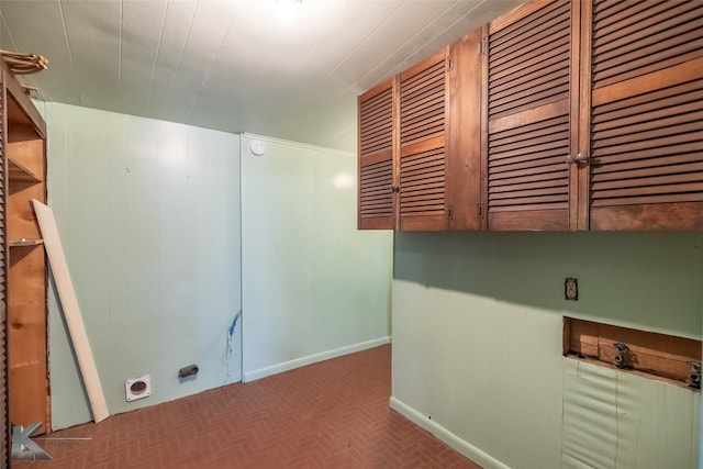 laundry room featuring baseboards, cabinet space, and electric dryer hookup