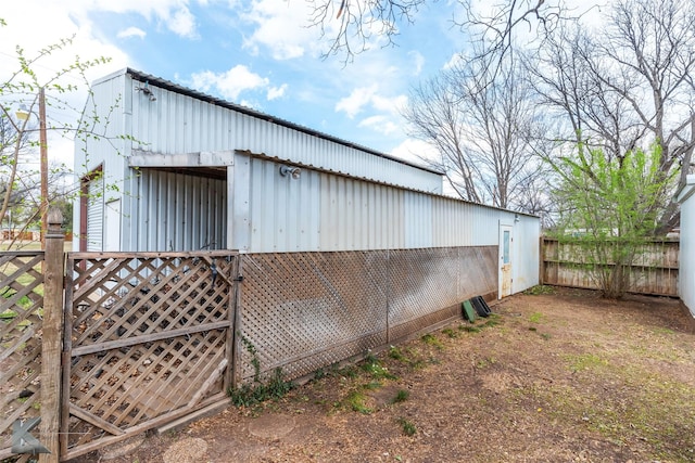 view of outdoor structure featuring an outbuilding and fence
