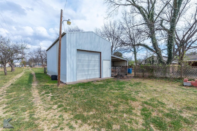 exterior space featuring a garage and fence