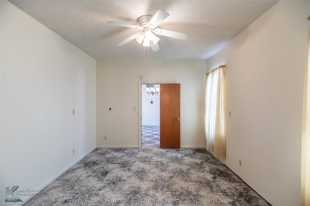 unfurnished room featuring a textured ceiling, carpet, and ceiling fan with notable chandelier
