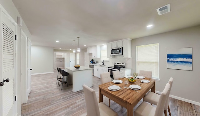 5609 Maceo Ln, Fort Worth, TX 76112 - dining room featuring baseboards, recessed lighting, and light wood-style floors