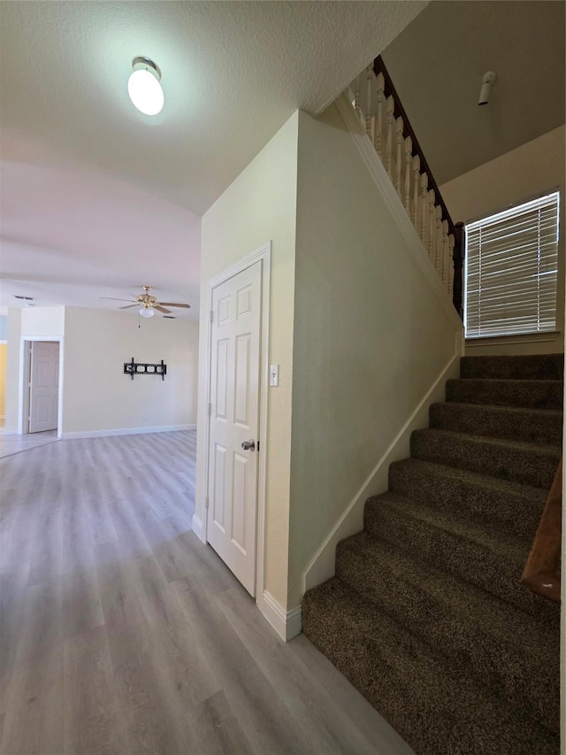 701 Canal St, Irving, TX 75063 - stairs featuring wood finished floors, a ceiling fan, and baseboards