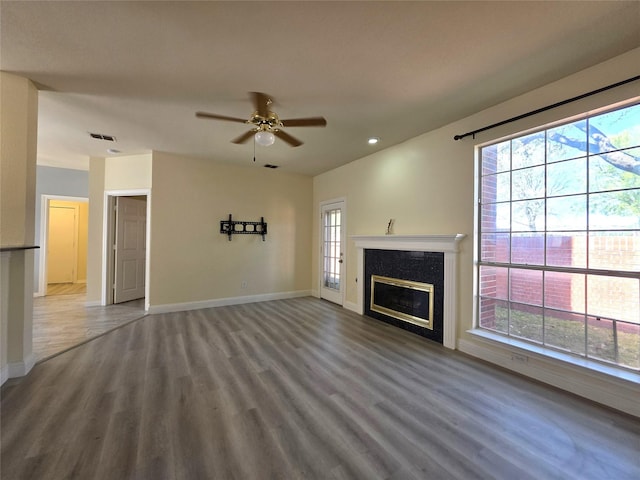 701 Canal St, Irving, TX 75063 - unfurnished living room featuring baseboards, wood finished floors, a ceiling fan, a glass covered fireplace, and recessed lighting