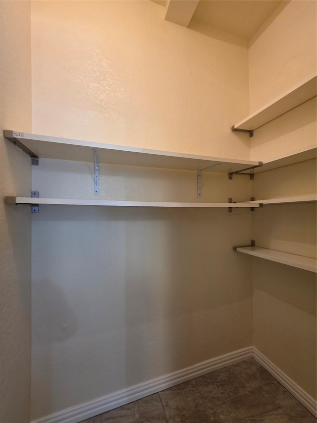 701 Canal St, Irving, TX 75063 - spacious closet with dark tile patterned flooring