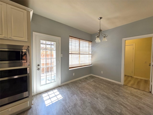 701 Canal St, Irving, TX 75063 - doorway to outside featuring a chandelier and baseboards