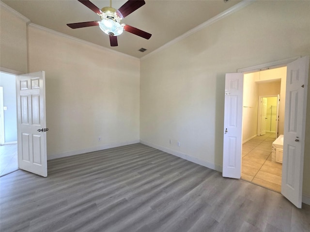 701 Canal St, Irving, TX 75063 - spare room with crown molding, ceiling fan, wood finished floors, baseboards, and high vaulted ceiling