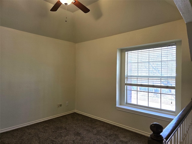 701 Canal St, Irving, TX 75063 - empty room featuring a ceiling fan, dark colored carpet, vaulted ceiling, and baseboards