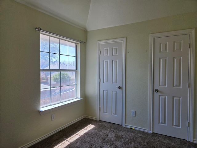 701 Canal St, Irving, TX 75063 - unfurnished bedroom with carpet flooring, lofted ceiling, and baseboards