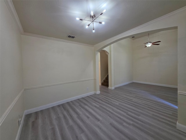 701 Canal St, Irving, TX 75063 - unfurnished room with arched walkways, crown molding, wood finished floors, a ceiling fan, and a chandelier