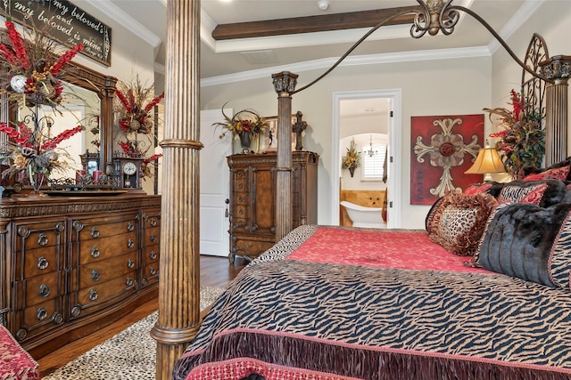 bedroom featuring decorative columns, crown molding, wood finished floors, and ensuite bathroom