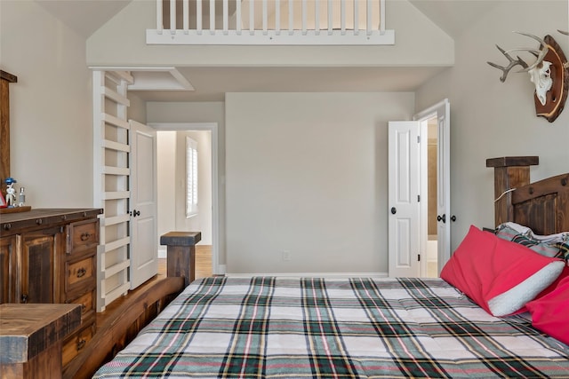 bedroom with a high ceiling and baseboards