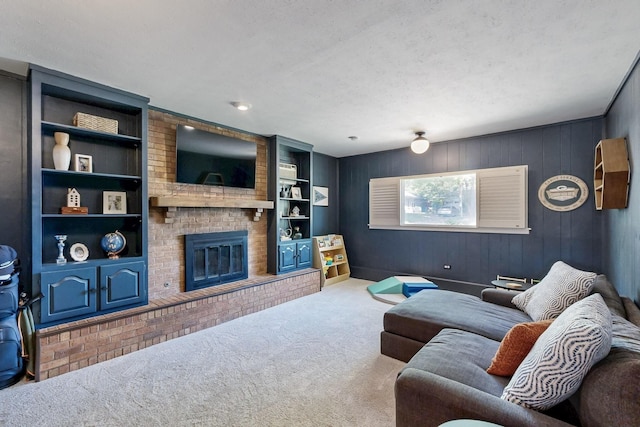carpeted living area with a fireplace, wooden walls, and built in shelves